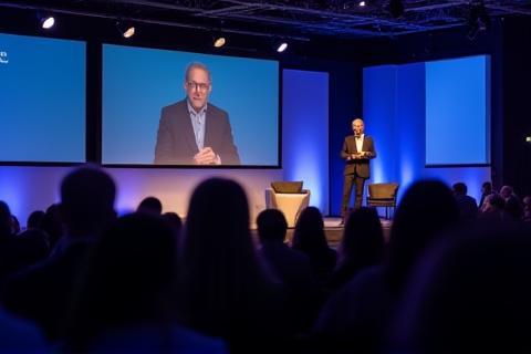 Conference event photography showing presenters on stage
